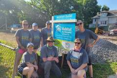 Morgan Miller team in Habitat T Shirts in front of Women Build sign