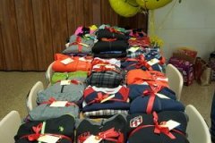 Table of wrapped clothing as gifts for Wishes with Wings Event