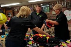 Morgan Miller team sorting clothing and gifts for Wishes with Wings event