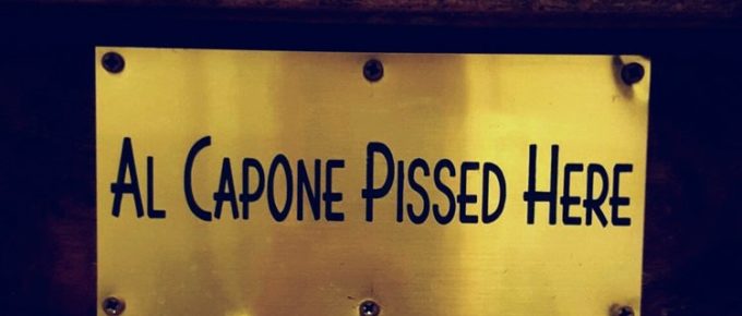 Brass sign reading "Al Capone pissed here"