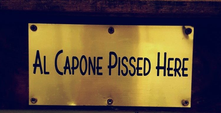 Brass sign reading "Al Capone pissed here"