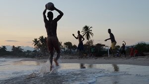 Men playing on a Haiti beach