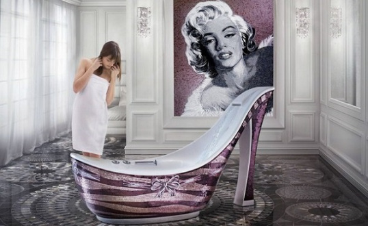 Woman peering into high heeled tub with a Marilyn Monroe painting behind her
