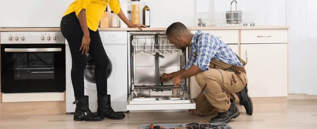Man inspecting dishwasher for customer